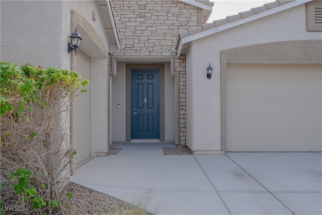 doorway to property with a garage