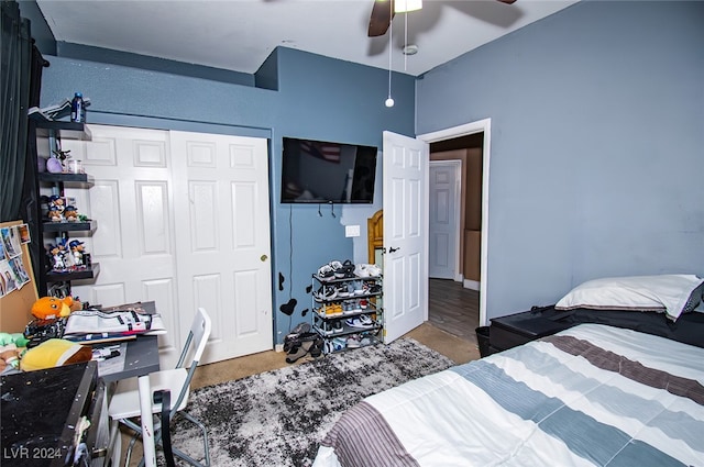 bedroom with a closet, hardwood / wood-style flooring, and ceiling fan