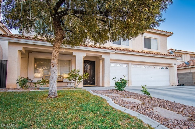 view of front of house featuring a garage and a front yard