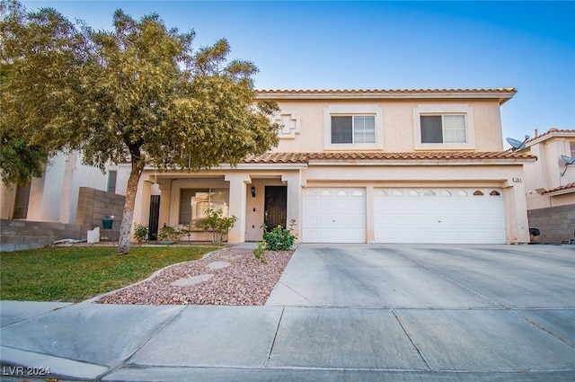 mediterranean / spanish-style home featuring a garage