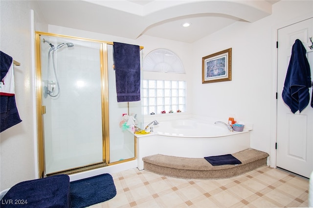 bathroom featuring shower with separate bathtub