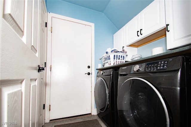 laundry area with washer and clothes dryer and cabinets