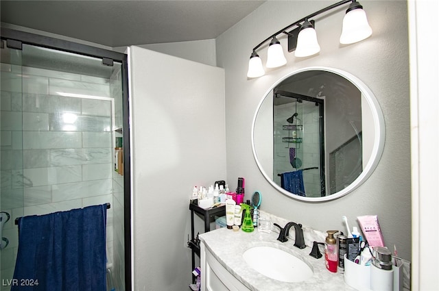 bathroom featuring vanity and an enclosed shower