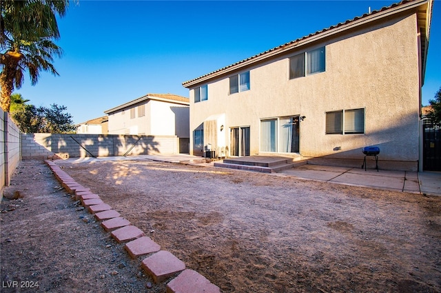 back of house with a patio