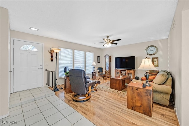 living room featuring ceiling fan and light hardwood / wood-style flooring