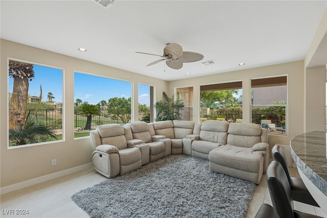 living room featuring light tile patterned floors and ceiling fan