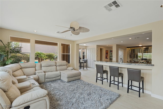 living room with ceiling fan and light tile patterned floors