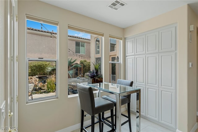 tiled dining area with plenty of natural light