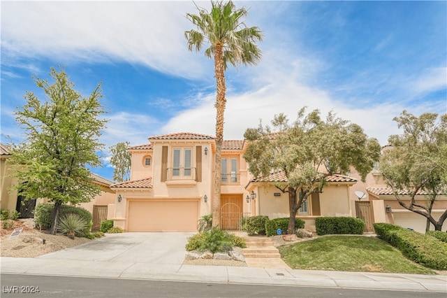 mediterranean / spanish-style home with a garage