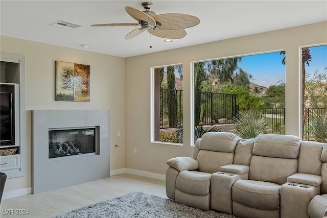 living room with light hardwood / wood-style floors and ceiling fan