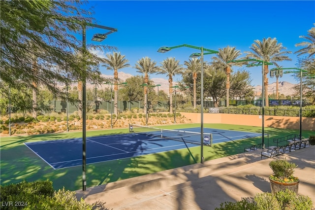 view of sport court with a mountain view and tennis court