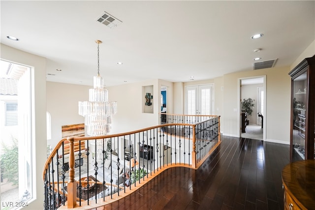 hallway featuring french doors, a chandelier, and dark hardwood / wood-style flooring