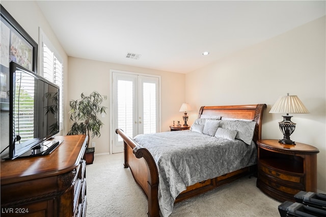 bedroom featuring french doors and light colored carpet