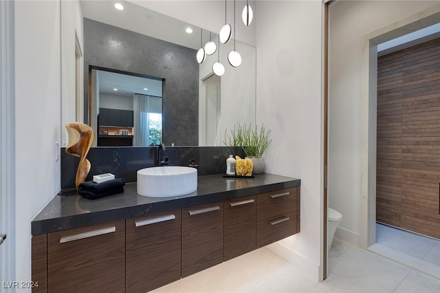 bathroom featuring vanity, tile patterned floors, and toilet