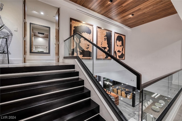 staircase with wood ceiling