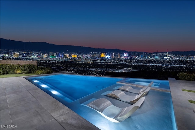 view of pool at dusk