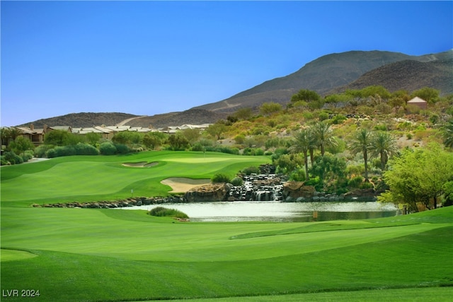 surrounding community with a water and mountain view and a yard