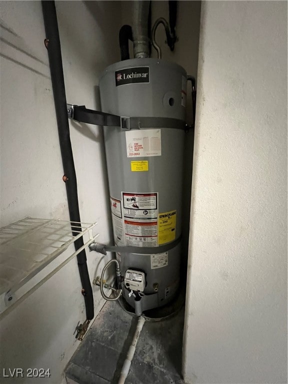 utility room featuring strapped water heater