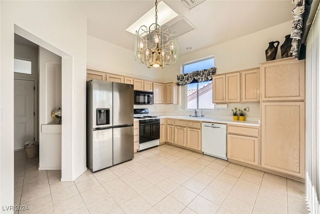 kitchen featuring pendant lighting, white appliances, light tile patterned floors, light brown cabinetry, and a notable chandelier