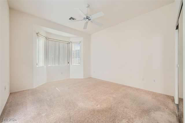 carpeted empty room with ceiling fan