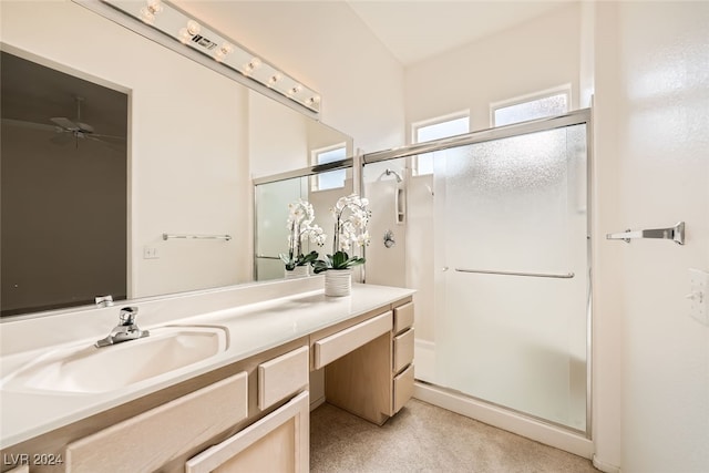 bathroom featuring vanity, ceiling fan, and an enclosed shower