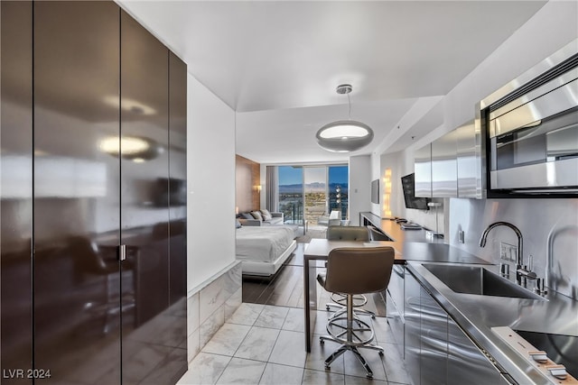 kitchen featuring light hardwood / wood-style flooring, sink, and cooktop