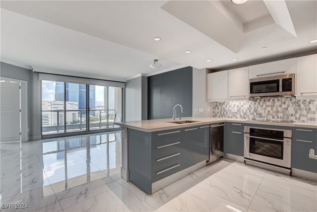 kitchen with white cabinetry, gray cabinets, stainless steel appliances, and decorative backsplash