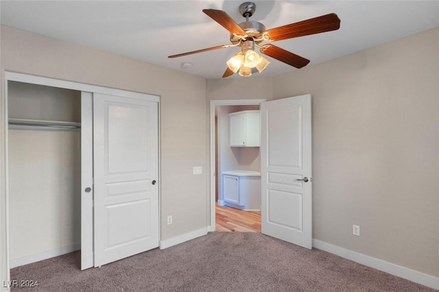 unfurnished bedroom featuring ceiling fan, baseboards, a closet, and light colored carpet