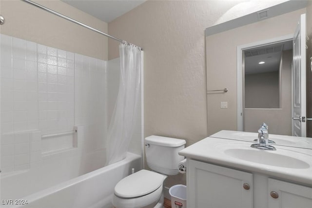 full bathroom with shower / bath combo, a textured wall, vanity, and toilet