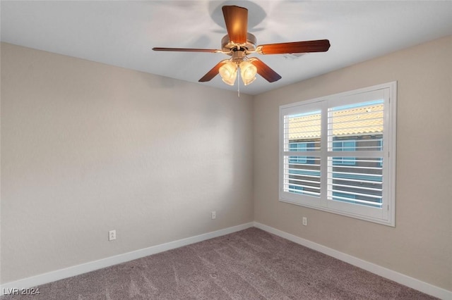 empty room featuring ceiling fan, carpet, and baseboards