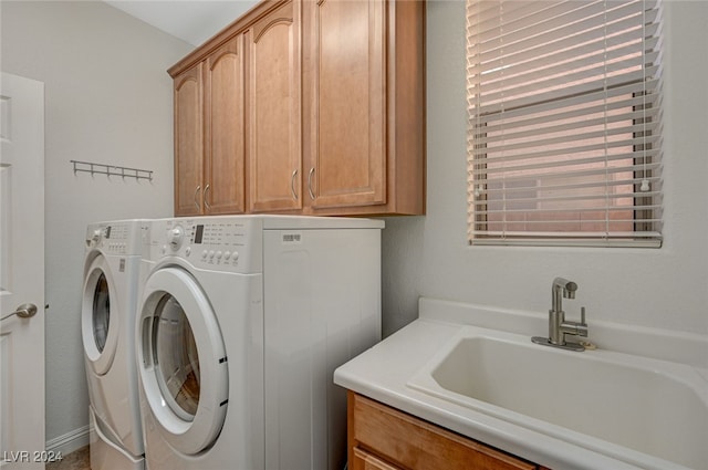 laundry area with cabinets, sink, and washing machine and clothes dryer