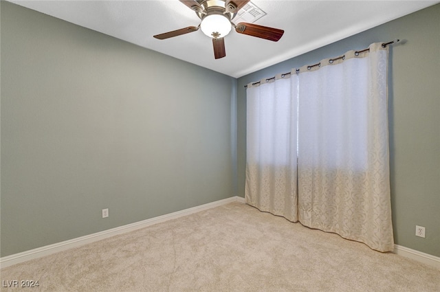 unfurnished room featuring light colored carpet and ceiling fan