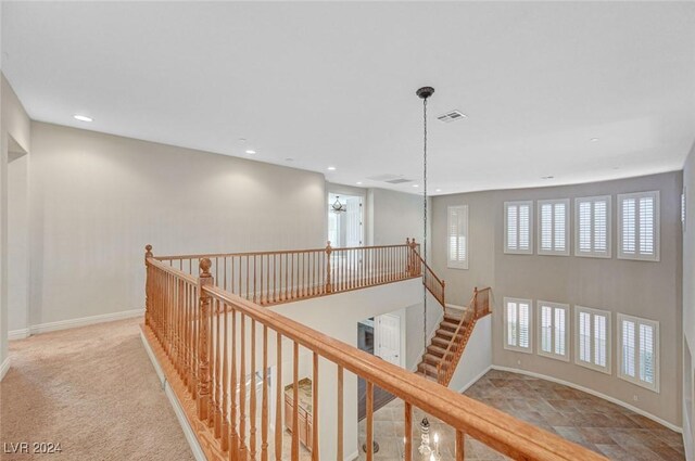 corridor featuring light colored carpet