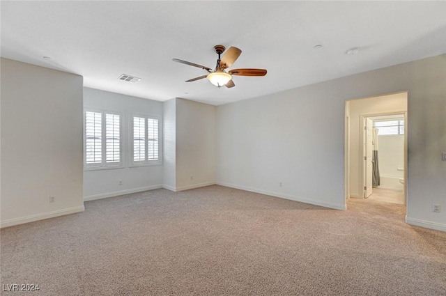 empty room with ceiling fan and light colored carpet