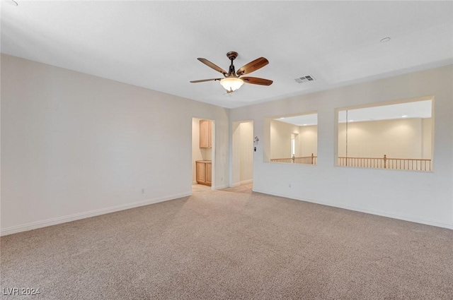 empty room with light carpet and ceiling fan