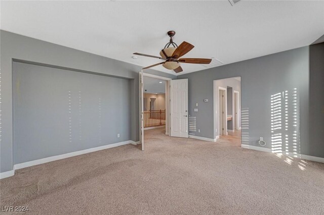 unfurnished bedroom featuring ceiling fan and light colored carpet