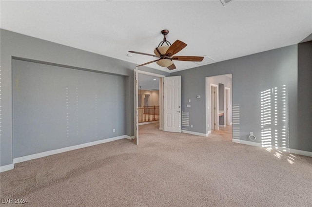 unfurnished bedroom featuring light colored carpet and ceiling fan