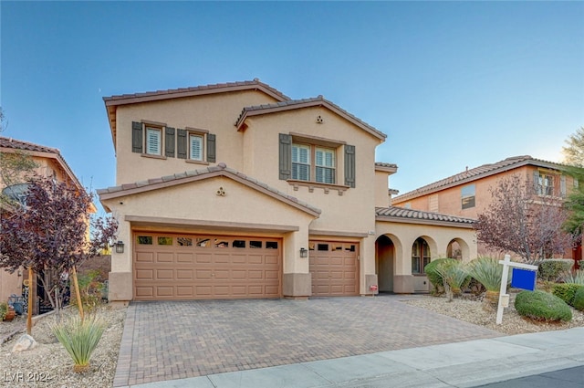 mediterranean / spanish house featuring a garage