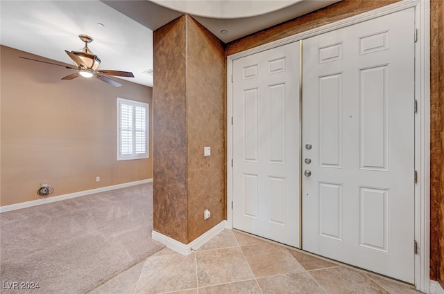 tiled entryway with ceiling fan