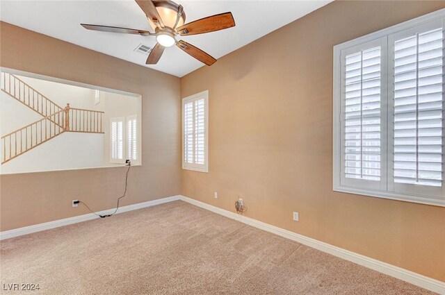 unfurnished room featuring carpet floors and ceiling fan