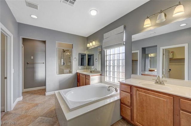 bathroom featuring vanity and separate shower and tub