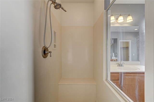 bathroom with walk in shower and vanity