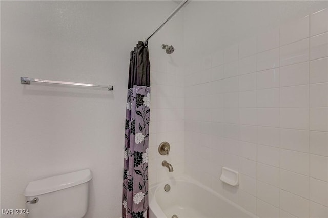 bathroom featuring shower / bathtub combination with curtain and toilet