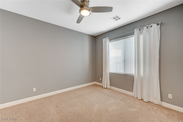 unfurnished room featuring light carpet and ceiling fan