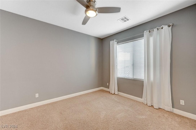 unfurnished room featuring light colored carpet and ceiling fan