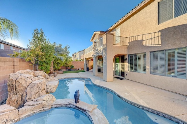 view of swimming pool featuring a patio area and an in ground hot tub