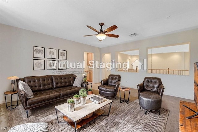 living room featuring ceiling fan and carpet