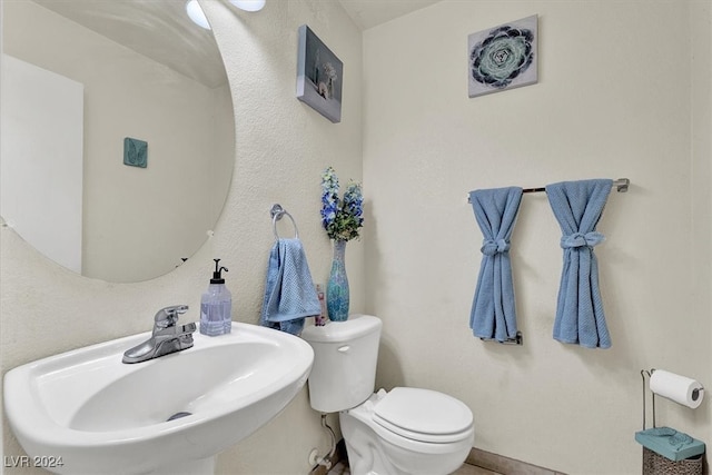 bathroom featuring sink and toilet