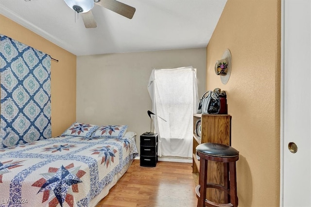 bedroom with light hardwood / wood-style floors and ceiling fan