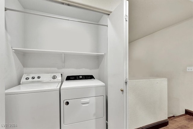 laundry area with hardwood / wood-style flooring and independent washer and dryer